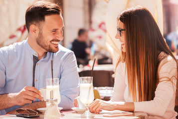 Romantic couple drinking coffee and lemonade, having a date in the cafe. Dating, love, relationships