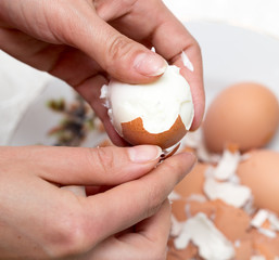 The girl is cleaning the egg with her hands