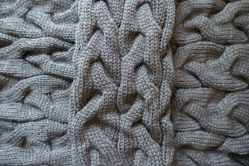 Cross of grey knit fabric with plait pattern