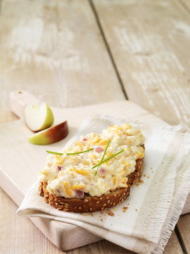 High angle view of grated cheese and red onion on wholemeal bread with apple wedges