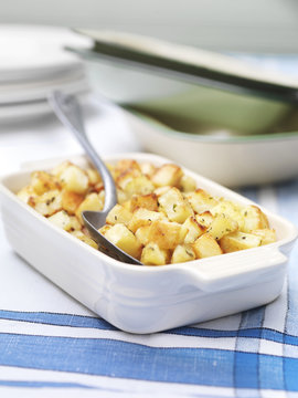 Dish of parmentier potatoes on vintage table cloth