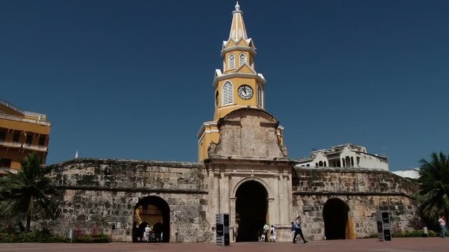 People going through old entrance of walled city in Cartagena, Colombia