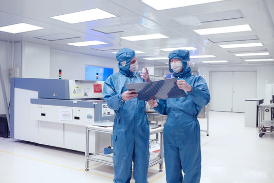 Male Worker Holding Flex Circuit In Flexible Electronics Factory Clean Room