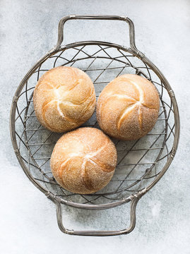 Overhead view of bread rolls in metal basket