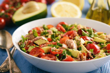 Healthy salad with tuna,cherry tomatoes and avocado. Selective focus.