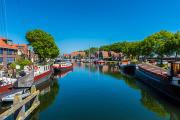 Fototapeta na wymiar Canal with Houseboats in Enkhuizen Netherlands