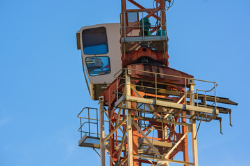 Fototapeta na wymiar Close up construction crane builds new building