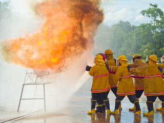 Firefighters training. spraying water fire fighting operation.
