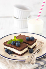 Chocolate biscuit with milk filling and berries on a plate. Chocolate-milk kids dessert. - 159610692