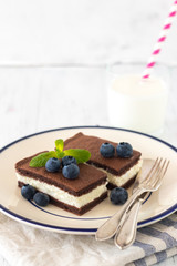 Chocolate biscuit with milk filling and berries on a plate. Chocolate-milk kids dessert. - 159610693