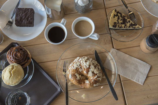 Set up shot of varity bread and cake with hot coffee break