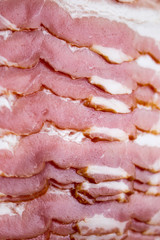Close-up, background of raw bacon, a popular meat product, ingredient of many dishes.