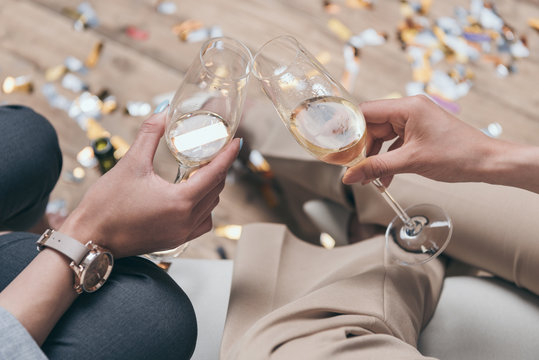 Cropped Shot Of Women Celebrating And Drinking Champagne At Home