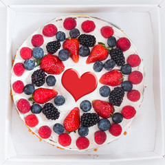 festive cake with berries and heart shape, top view