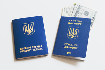 Biometric passport of ukraine with dollar bills on a white background.