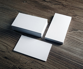 Three stacks of blank business cards stacks on wood table background. Template for your design.