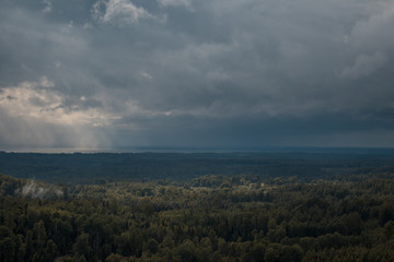 Fototapeta na wymiar aerial view over the green forest in evening. Cloudy mystery. Landscapes of Latvia