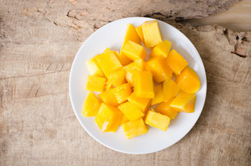Sliced mango fruit on white dish ready to eating