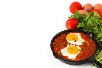 Mexican breakfast: Huevos rancheros in iron frying pan isolated on white background
