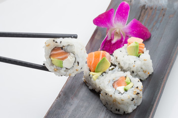 Eating Salmon cream cheese rolls with Chopsticks