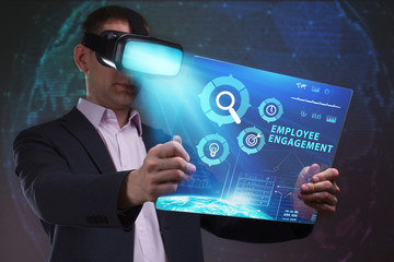Business, Technology, Internet and network concept. Young businessman working in virtual reality glasses sees the inscription: Employee engagement