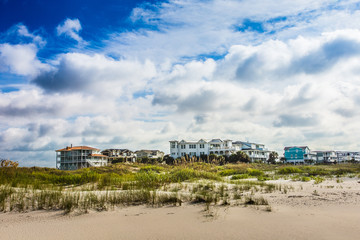 Beautiful coastal beach lined by beach houses and sand dunes