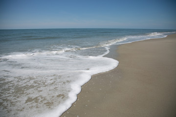 Morning tide on the sandy beach on the ocean
