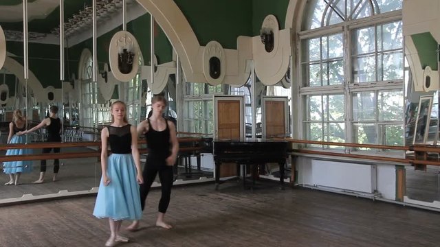 Two ballet dancers do element in pair