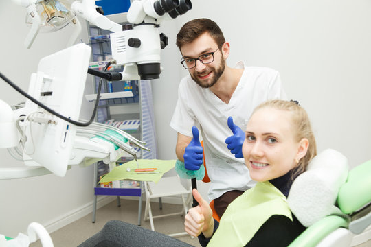 Smiling dentist and his cheerful patient