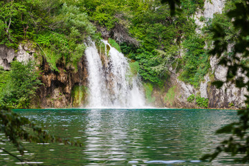 Fototapeta na wymiar Beautiful summer green forest waterfall