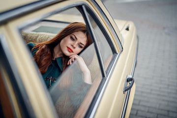 Fototapeta na wymiar A woman is sitting in the car with an open window