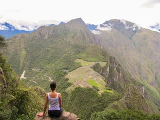 Foto op Canvas Woman at the top of Wayna Picchu mountain in Machu Picchu, Peru © Helissa