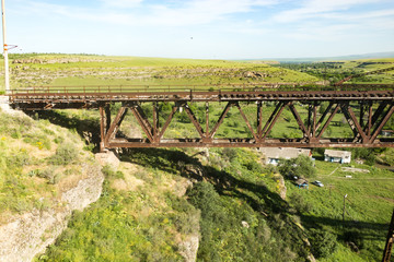 Fototapeta na wymiar Old metal bridge with a railway