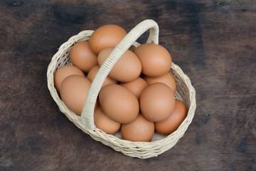Chicken Egg in a basket on wooden table