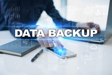 Businessman working in office, pressing button on virtual screen and selecting data backup.