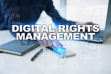 Businessman working in office, pressing button on virtual screen and selecting digital rights management.