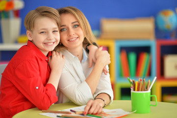 Fototapeta premium Mother with her son draw with pencils