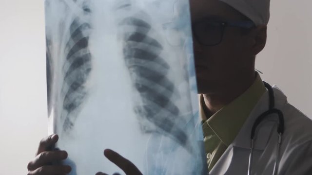The doctor is studying an X-ray. A medical worker makes a bad diagnosis