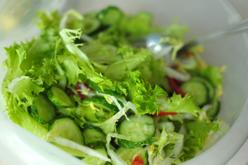 fresh vegetable salad with tomato, cucumber and salad frisee
