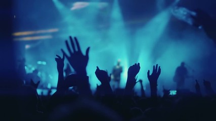 Iconic night rock concert front row crowd cheering hands in air slomo 100p