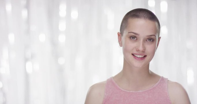 Portrait of confident grungy woman smiling at camera
