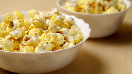 big and small bowls of popcorn, shallow depth of field, 16:9 ratio