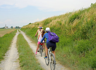 Three people with two bicycles along the cycle path