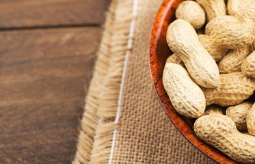 From above plate with whole peanuts on canvas bag. Copy space.