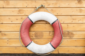Lifebuoy hanging on a wooden wall.