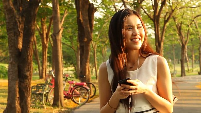 Thai pretty woman talkative with smartphone