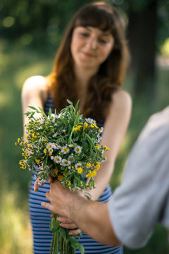 Surprise for girl gift flowers young surprised girl in the park.