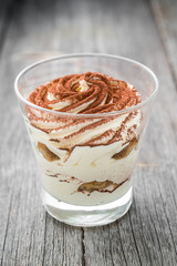 Traditional Italian dessert tiramisu in a glass.