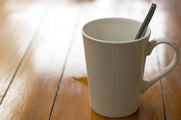 Coffee in white cup on wooden table