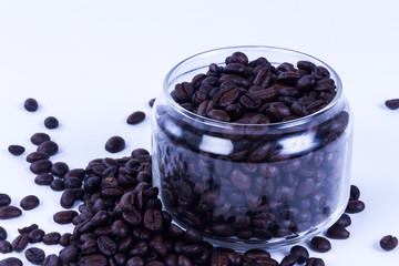 Coffee beans in the jar on dark wood background